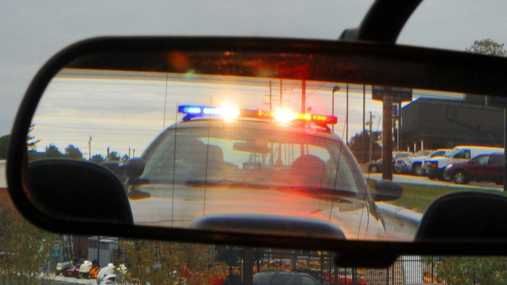 Police Car seen in Rear View Mirror